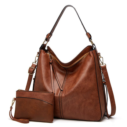Classic leather shoulder bag with sleek gold details