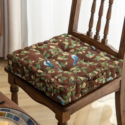Thick, padded seat cushion with straps for dining or patio chairs