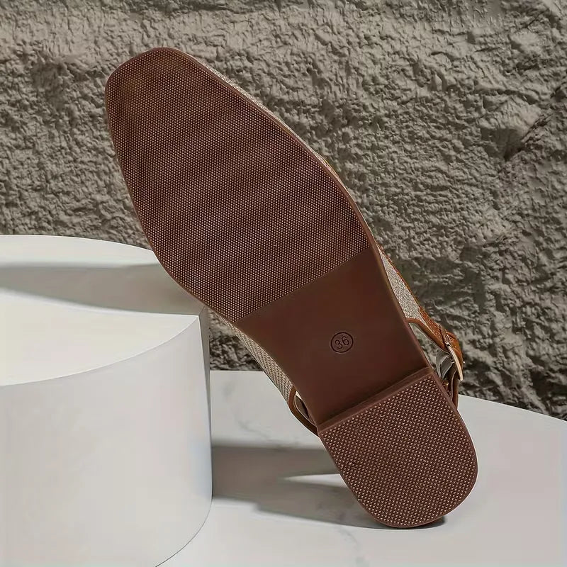Flat sandal with metallic buckle fastening