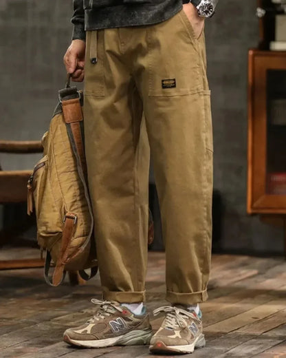 Cargo trousers with many pockets and rolled-up hems