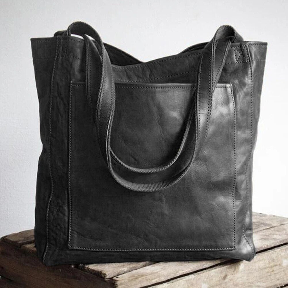 Leather bag with stain-resistant interior and zippered inner pocket