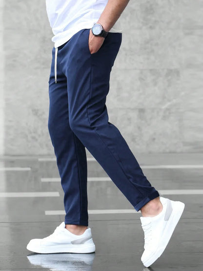Slim fit trousers with elastic waistband and side pockets