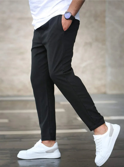 Slim fit trousers with elastic waistband and side pockets