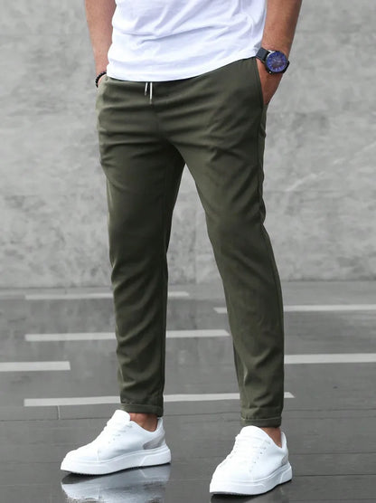 Slim fit trousers with elastic waistband and side pockets