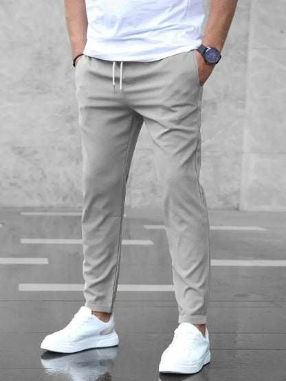 Slim fit trousers with elastic waistband and side pockets