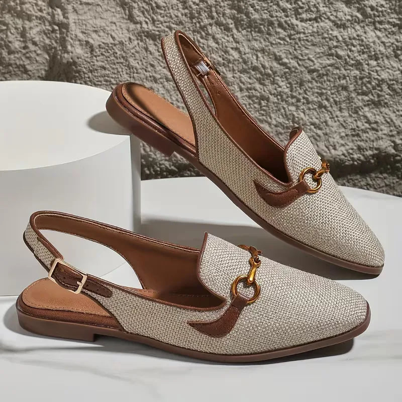 Flat sandal with metallic buckle fastening