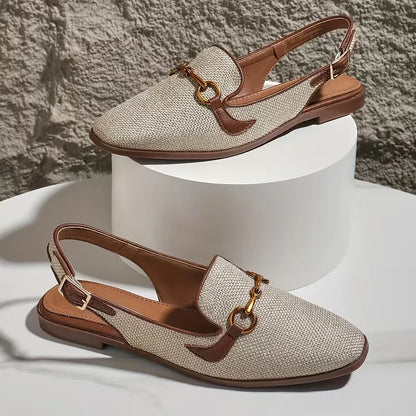 Flat sandal with metallic buckle fastening