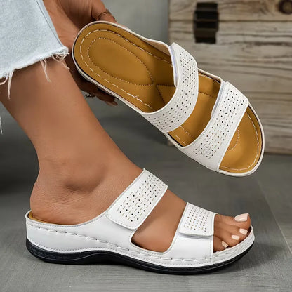Flat sandals with perforated straps